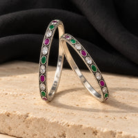 Classic oval silver bangles with multicolour stones, styled