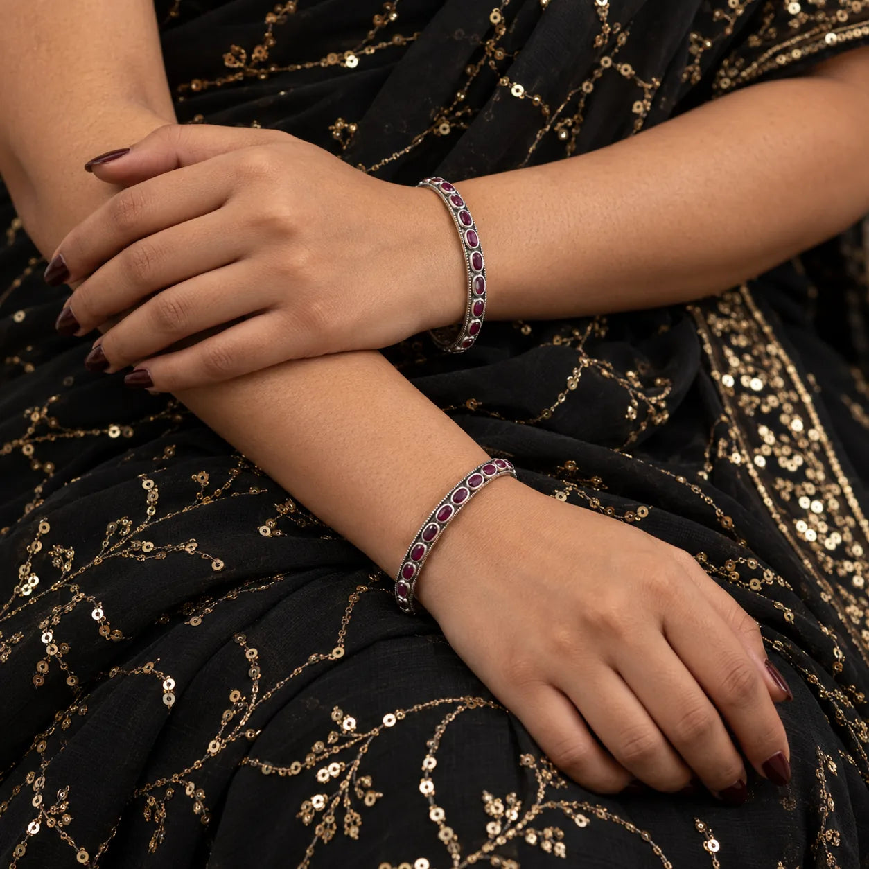 Classic oval red stone silver bangles worn on the wrist