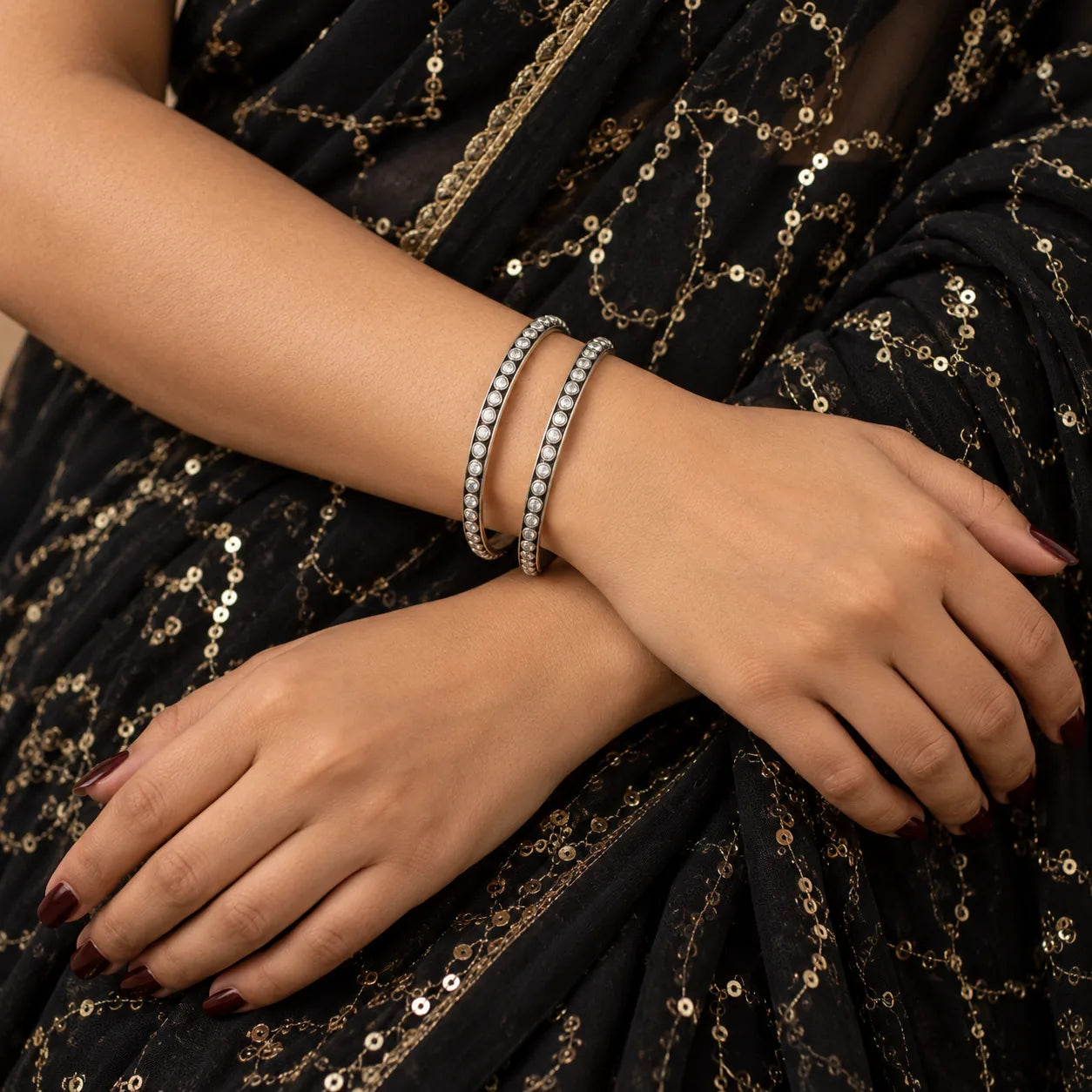 Classic round white stone silver bangles worn on the wrist