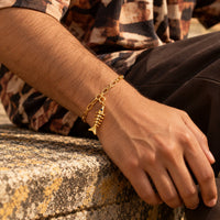 Gold finish fish charm on a chain bracelet