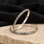 Floral engraved antique silver bangles, styled
