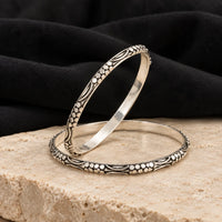 Floral engraved antique silver bangles, styled