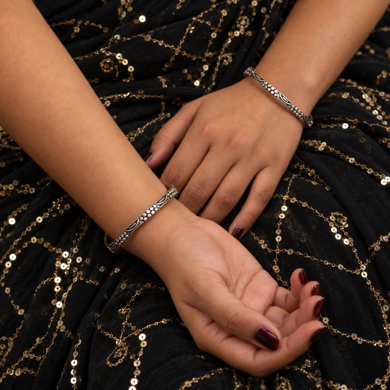 Floral engraved antique silver bangles worn on the wrist