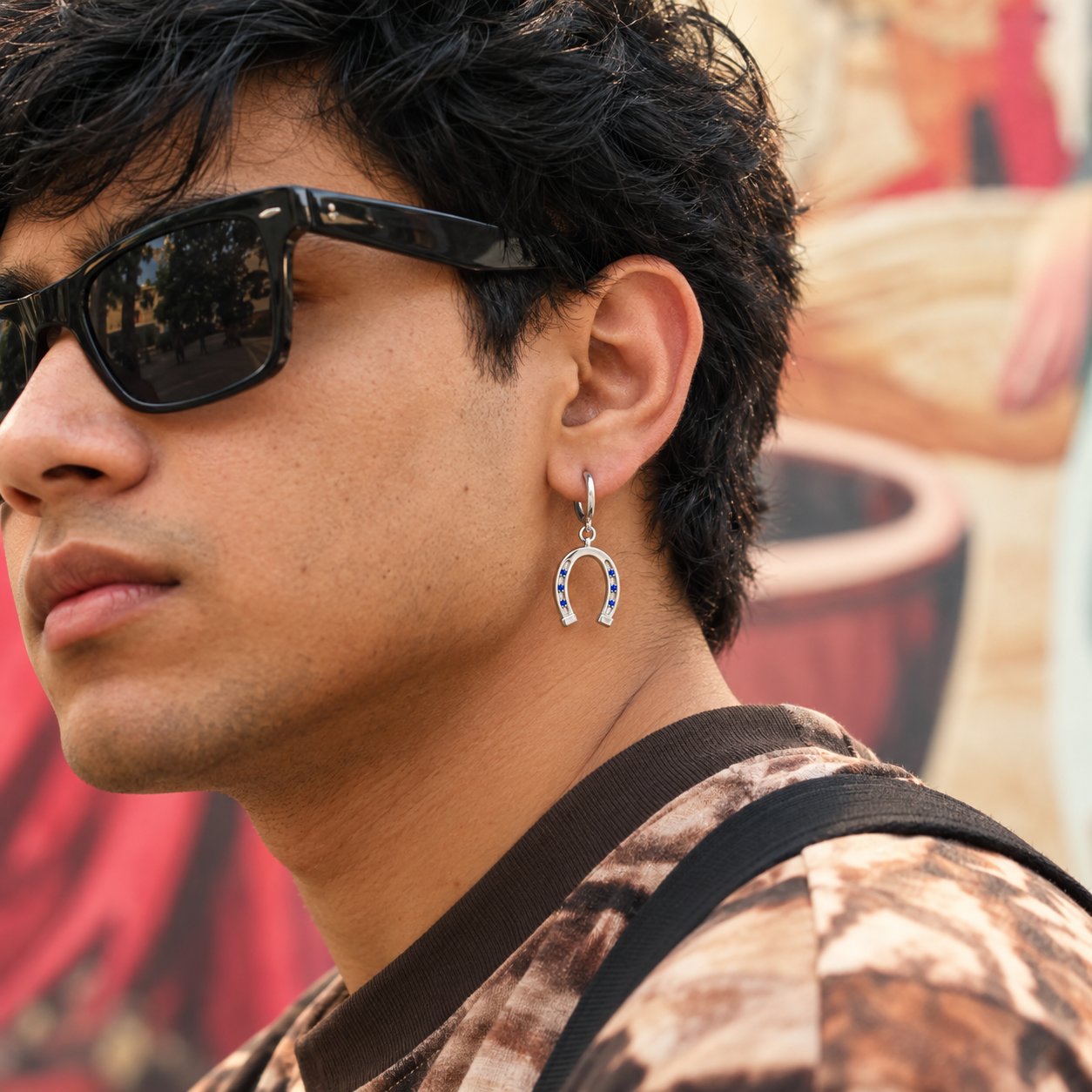 Horseshoe silver charm worn as an earring