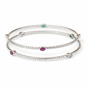 Multi stone silver bangles worn on the wrist