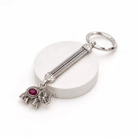 Regal elephant oxidised silver keychain with ruby-red stone