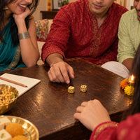 Gold finish silver dice on the table at a Diwali card night