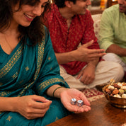 Pair of silver dice held in a palm at a Diwali gathering