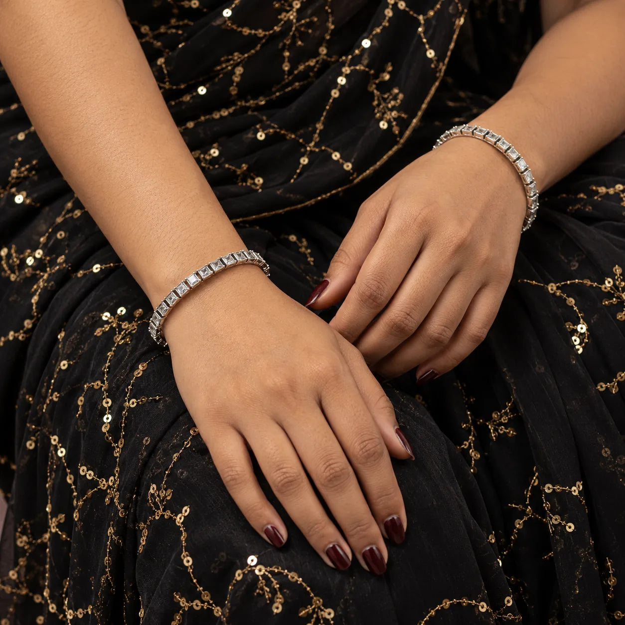 Square-set white stone silver bangles worn on the wrist