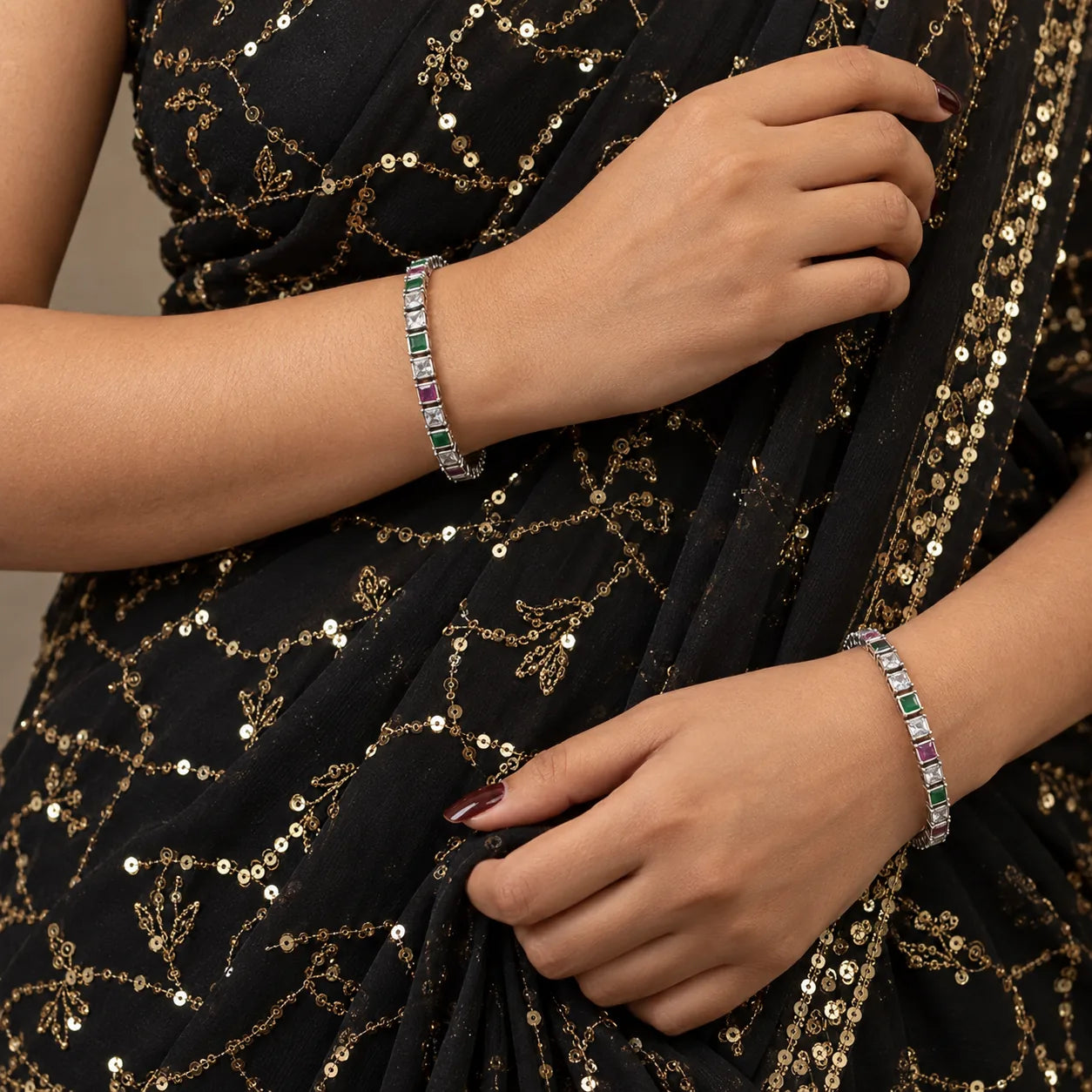 Square-set multicolour silver bangles worn on the wrist